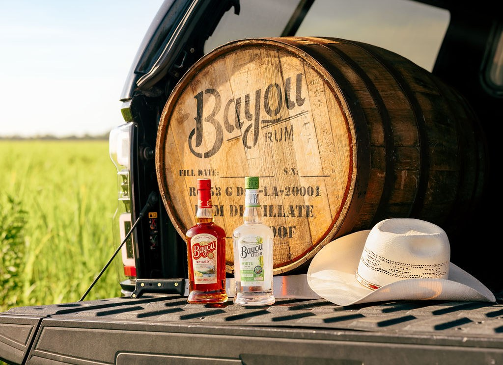 Bayou Rum bottles in front of a Louisiana barrel